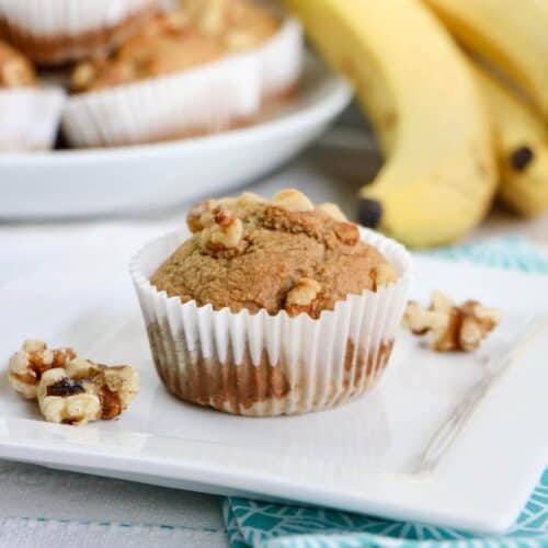 Banana oat muffins on a square white plate.